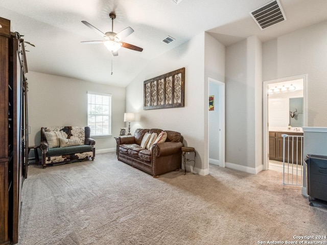 carpeted living room with ceiling fan and lofted ceiling