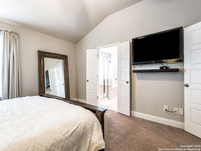 carpeted bedroom featuring ensuite bath and lofted ceiling