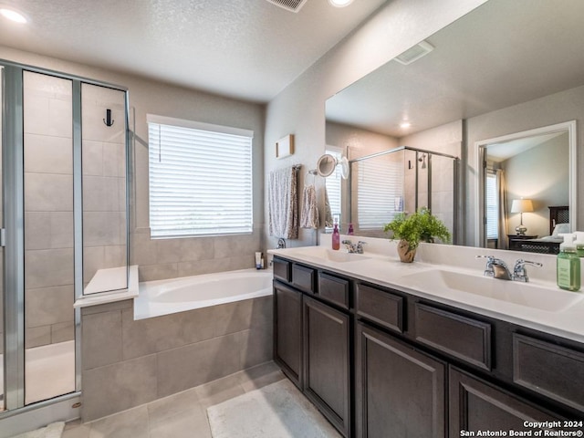 bathroom with separate shower and tub, tile patterned flooring, and vanity