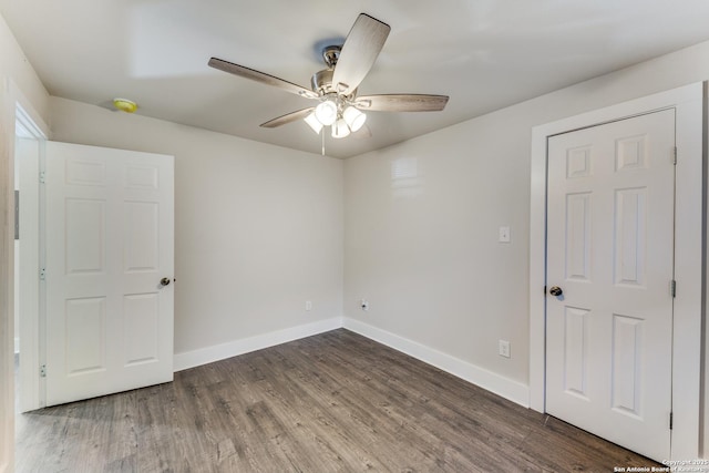 spare room featuring ceiling fan and dark hardwood / wood-style flooring