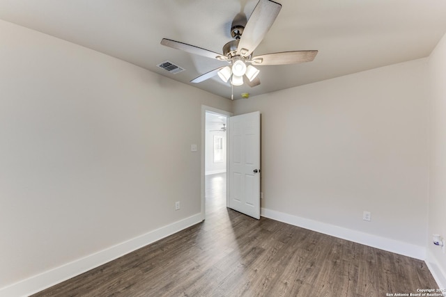 empty room featuring ceiling fan and dark wood-type flooring