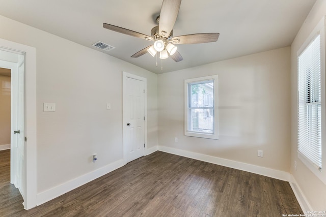 unfurnished bedroom with a closet, ceiling fan, and dark wood-type flooring