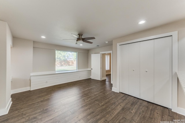 unfurnished bedroom with ceiling fan, a closet, and dark hardwood / wood-style floors