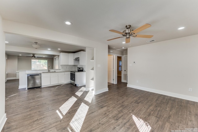 kitchen featuring dark hardwood / wood-style flooring, tasteful backsplash, stainless steel appliances, sink, and white cabinets