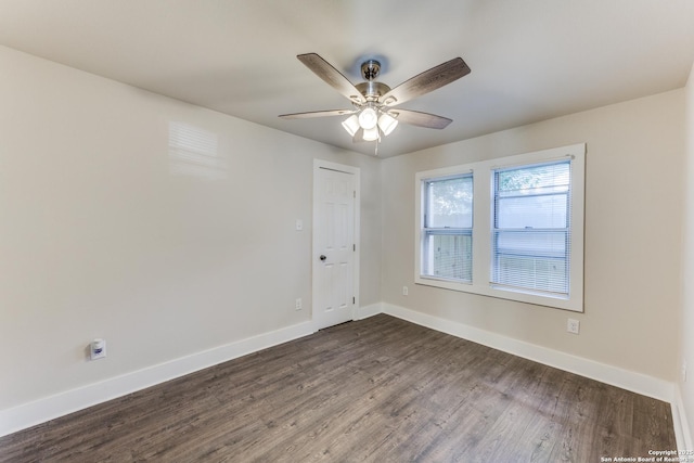 spare room with ceiling fan and dark wood-type flooring