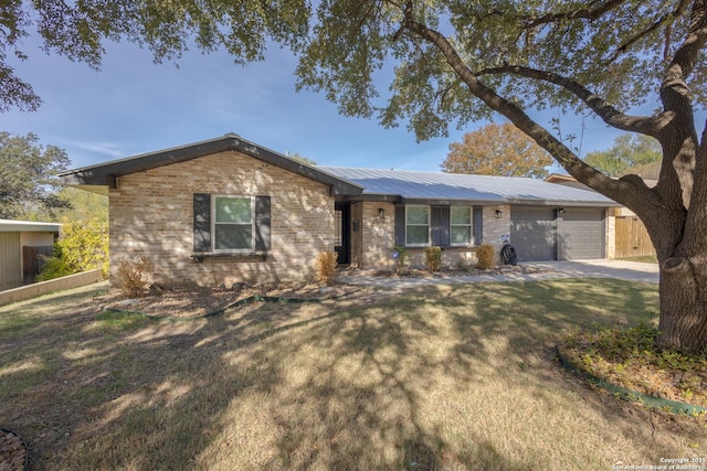 ranch-style home featuring a front yard and a garage