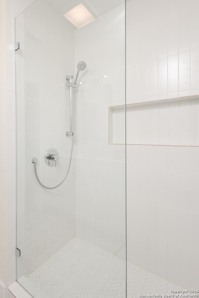 bathroom with a tile shower