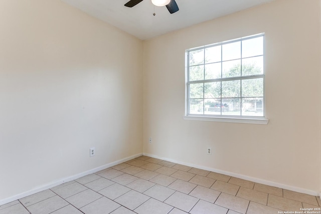 spare room featuring ceiling fan and light tile patterned floors