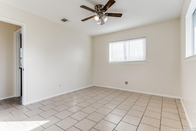 empty room featuring light tile patterned floors and ceiling fan