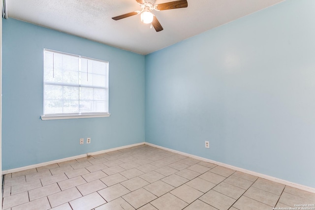 spare room featuring light tile patterned floors, a textured ceiling, and ceiling fan