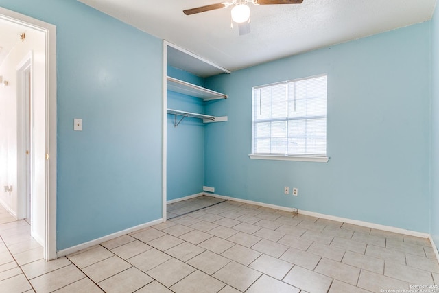 tiled spare room featuring ceiling fan