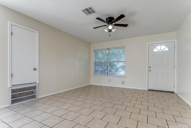 tiled foyer with ceiling fan