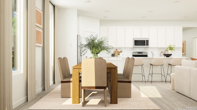 dining area featuring sink and light wood-type flooring