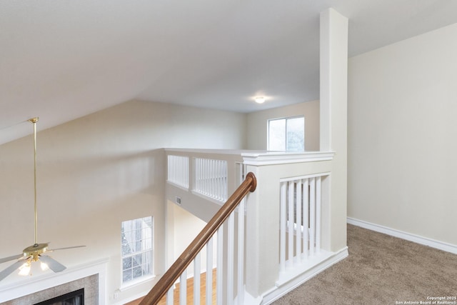 hallway with carpet and vaulted ceiling