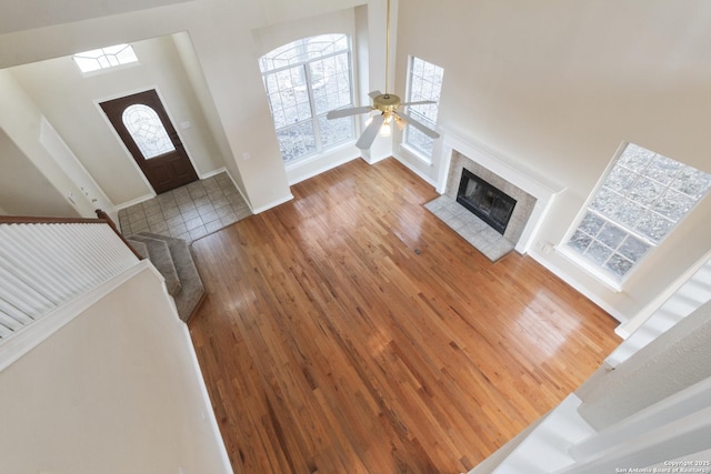 entrance foyer featuring a fireplace, hardwood / wood-style floors, and ceiling fan