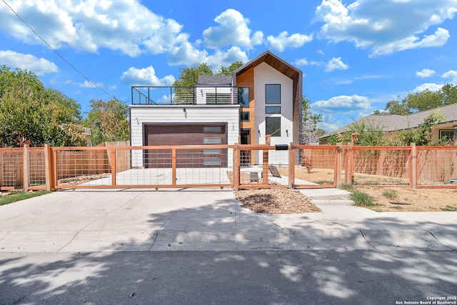 modern home featuring a balcony and a garage