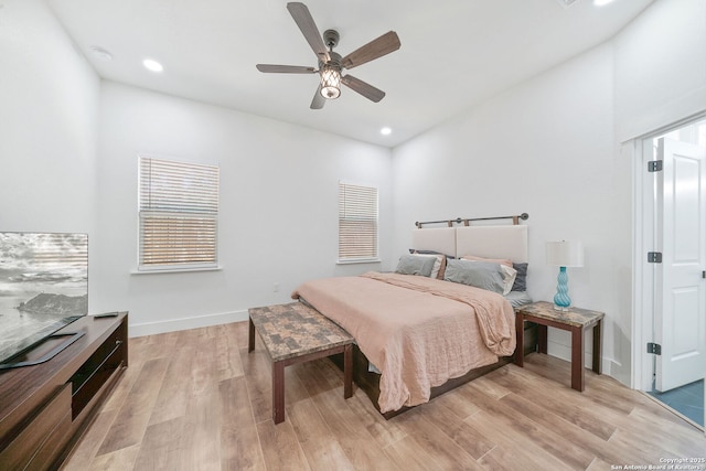 bedroom with ceiling fan and light hardwood / wood-style flooring