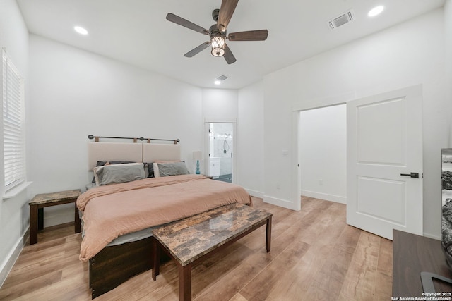 bedroom featuring connected bathroom, ceiling fan, and light wood-type flooring