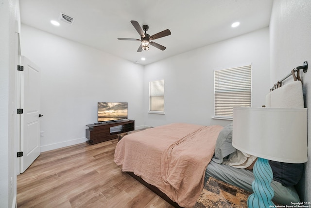 bedroom with ceiling fan and light hardwood / wood-style floors