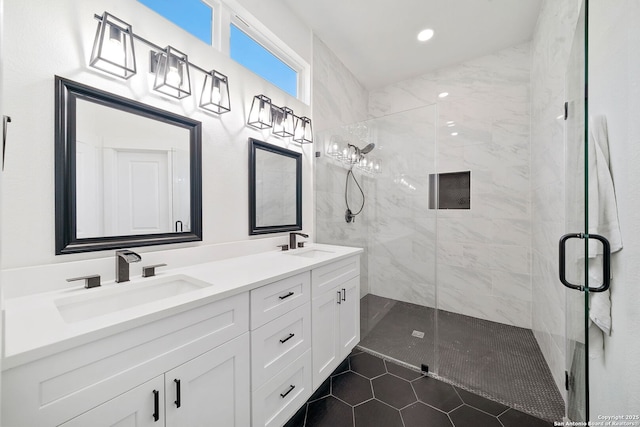 bathroom featuring tile patterned floors, a shower with door, and vanity