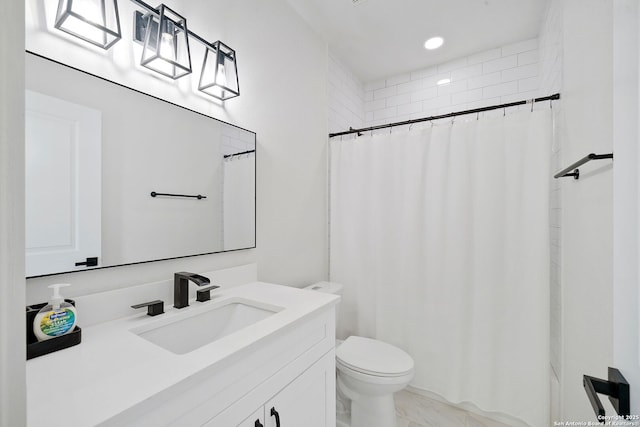 bathroom with vanity, toilet, and walk in shower