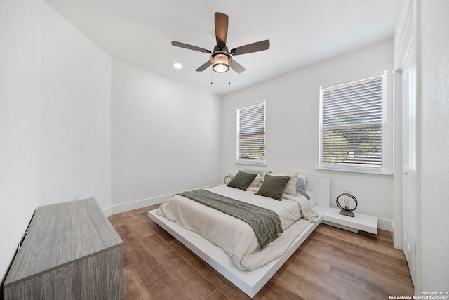 bedroom with hardwood / wood-style floors and ceiling fan