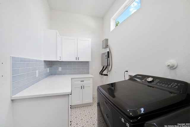 laundry room with cabinets and washer / dryer