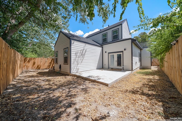 back of property with a patio area and french doors