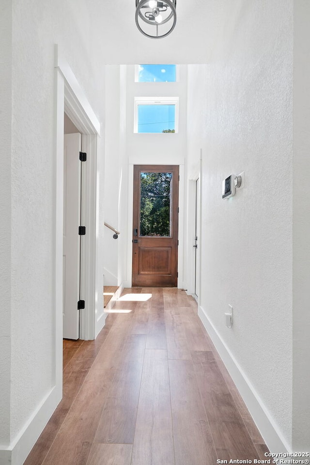 entryway with a chandelier and light hardwood / wood-style flooring