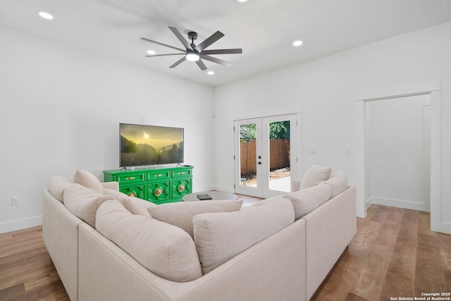 living room featuring ceiling fan, french doors, and wood-type flooring