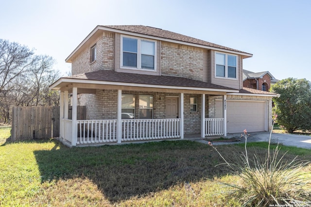 view of front of home featuring covered porch, a garage, and a front lawn