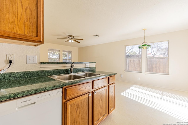 kitchen with white dishwasher, plenty of natural light, ceiling fan, and sink