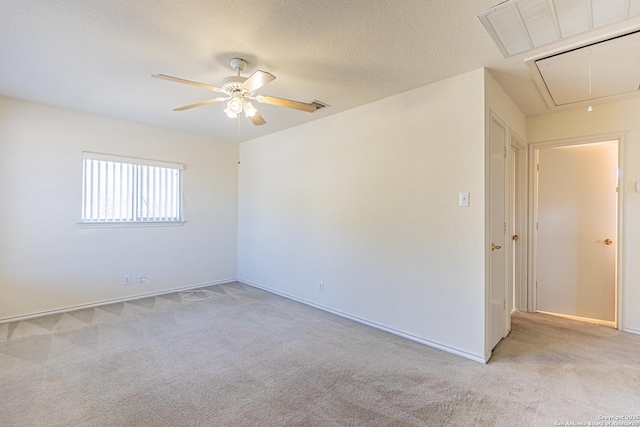 spare room featuring ceiling fan and light carpet