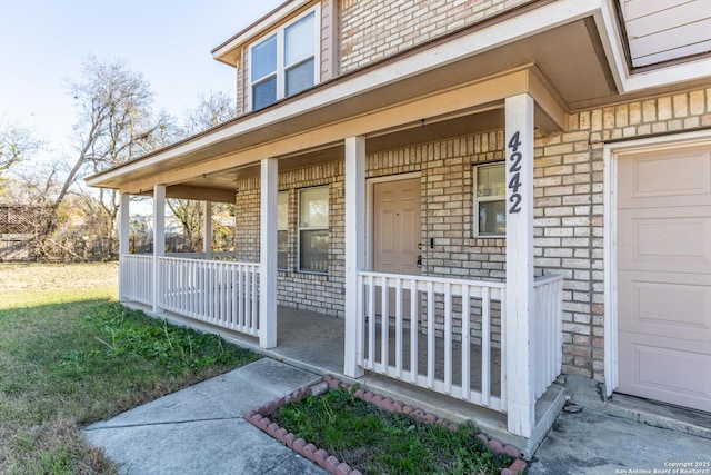 property entrance with a porch and a garage