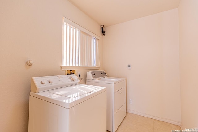 washroom with washing machine and clothes dryer