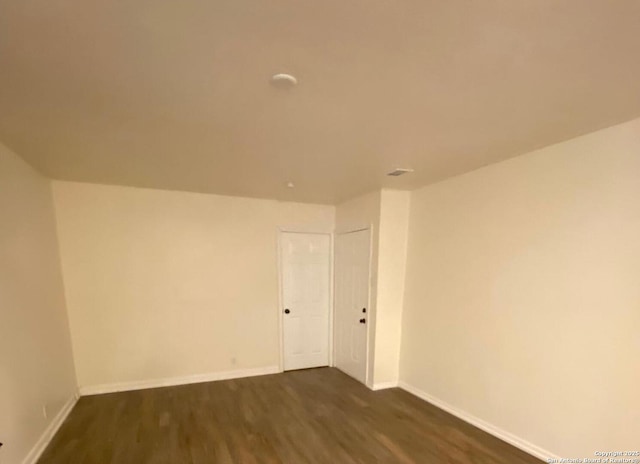 empty room with hardwood / wood-style flooring