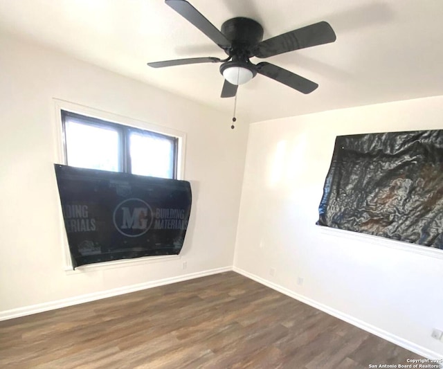 spare room with ceiling fan and dark wood-type flooring