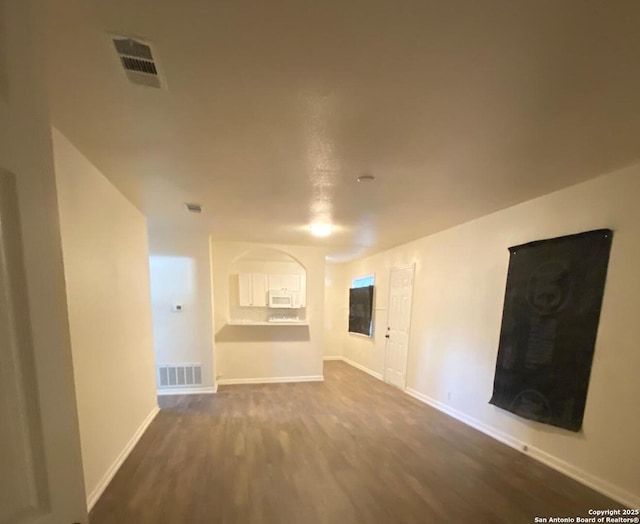 unfurnished living room featuring hardwood / wood-style floors