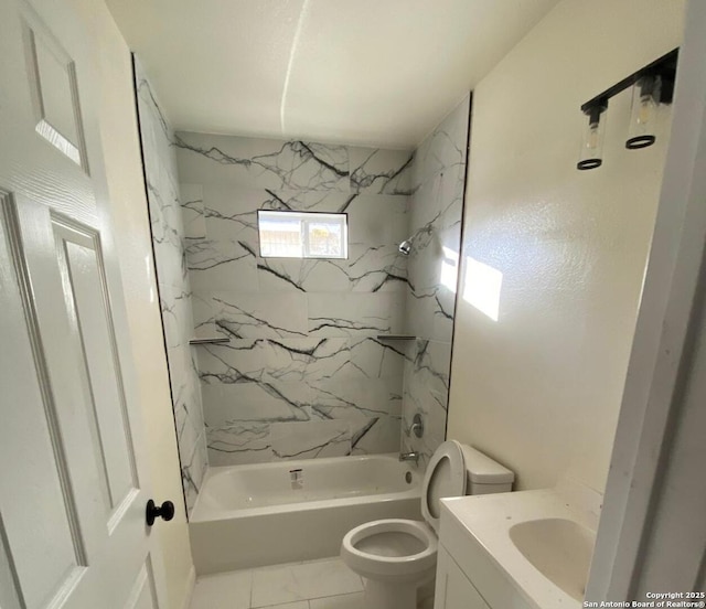 full bathroom with tile patterned floors, tiled shower / bath combo, toilet, and vanity