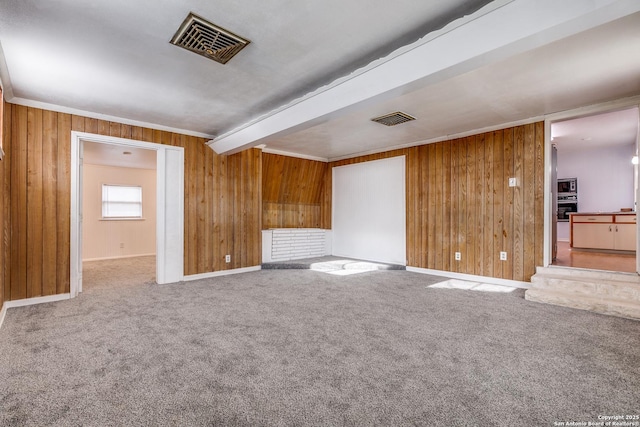 unfurnished living room with beam ceiling and carpet floors