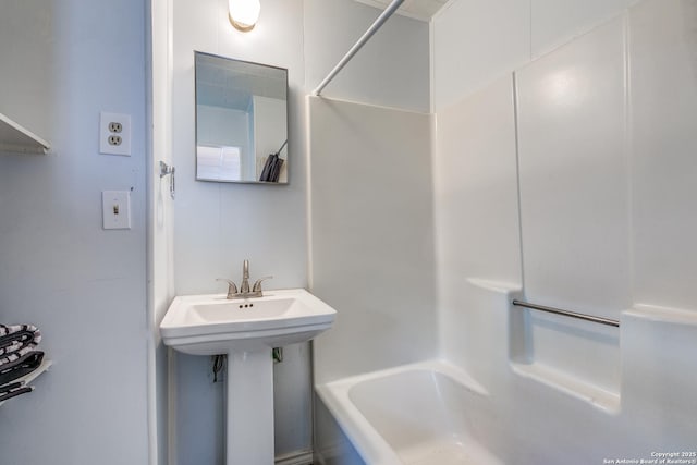 bathroom with shower / bath combination and sink