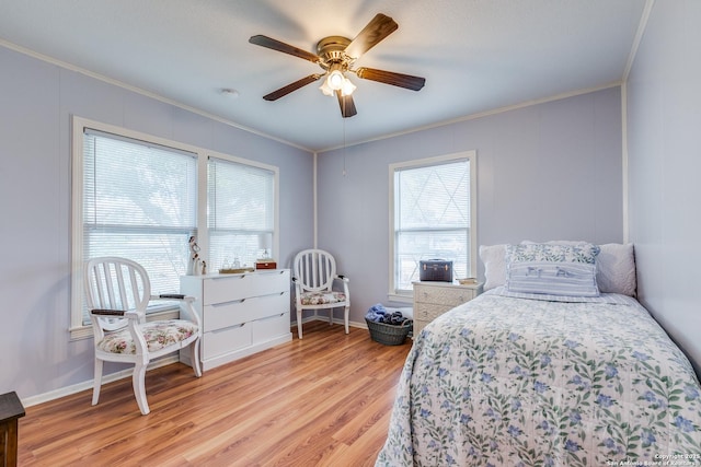 bedroom featuring multiple windows, ceiling fan, and ornamental molding