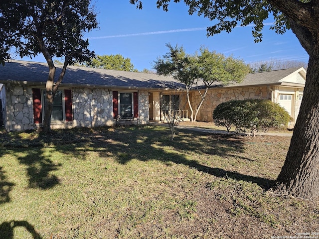 ranch-style house with a front yard and a garage