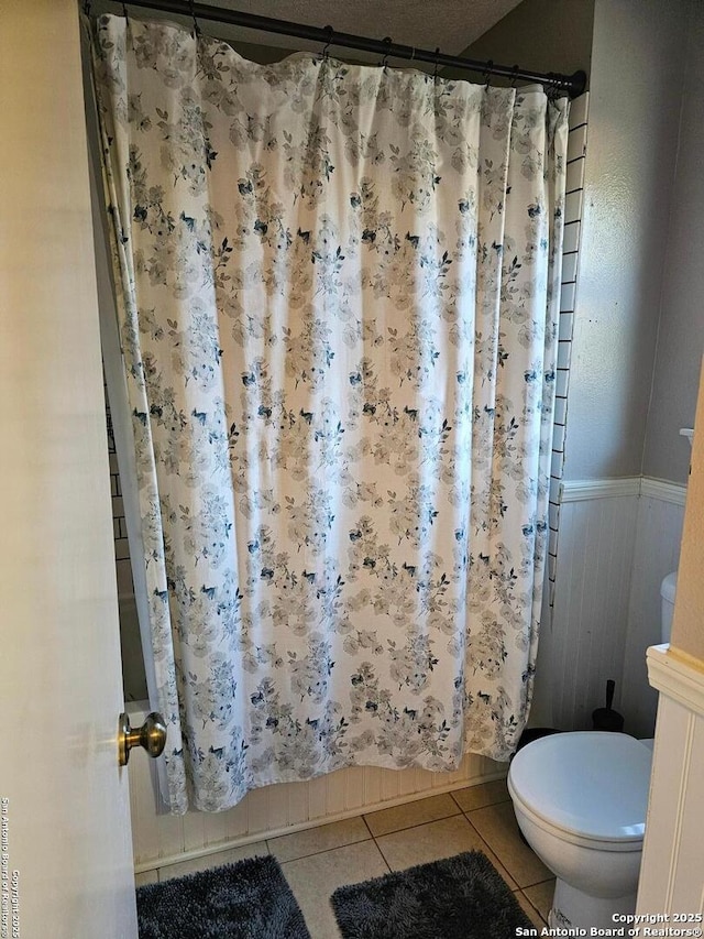 bathroom featuring tile patterned flooring and toilet