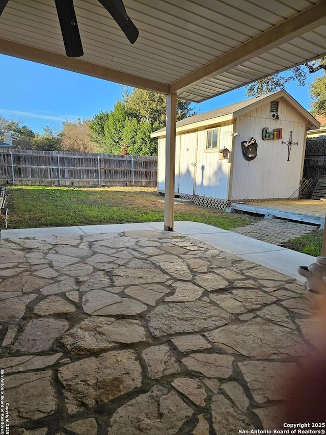 view of patio featuring an outbuilding and ceiling fan