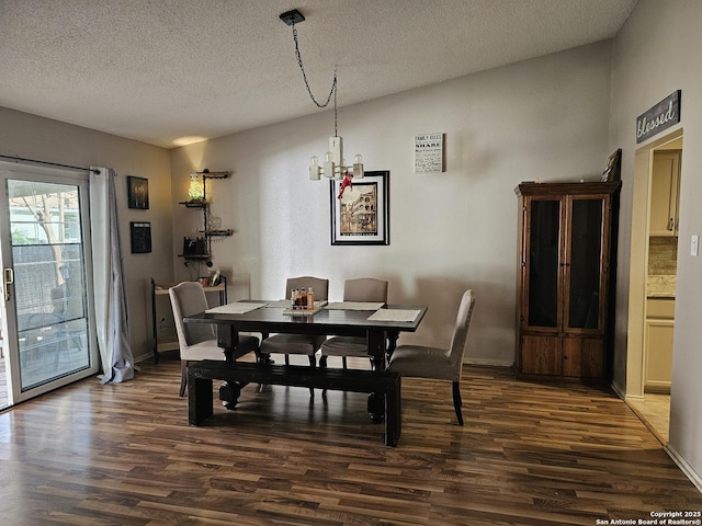 dining space featuring a textured ceiling, lofted ceiling, dark hardwood / wood-style floors, and a notable chandelier