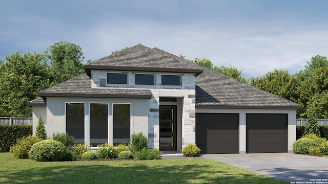 view of front of property with a garage and a front lawn