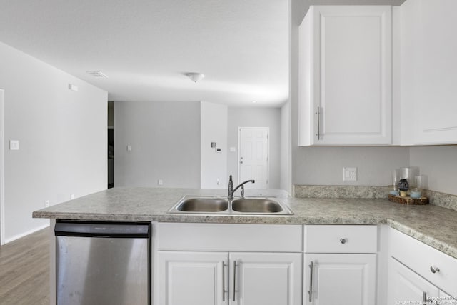 kitchen featuring dishwasher, light wood-type flooring, white cabinetry, and sink