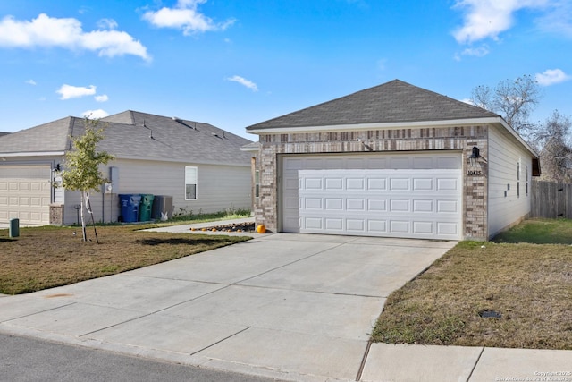 view of front facade with a garage and a front lawn