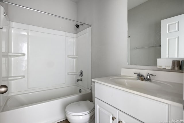 full bathroom featuring toilet, vanity, and washtub / shower combination